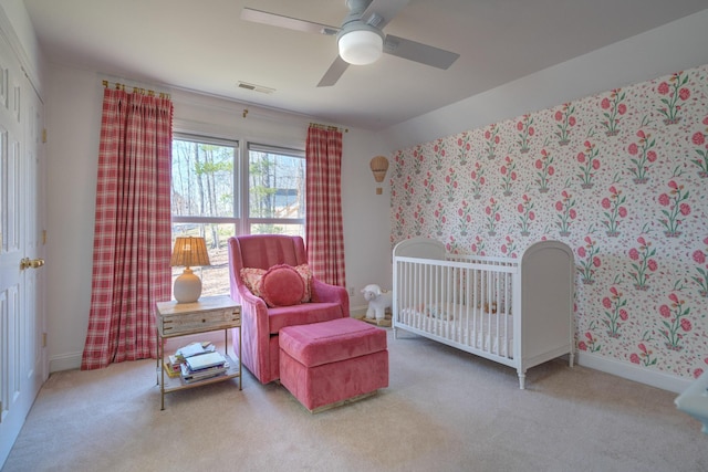 bedroom featuring carpet, visible vents, baseboards, wallpapered walls, and ceiling fan