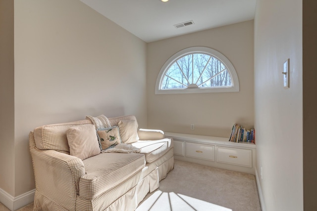 sitting room featuring light carpet, visible vents, and baseboards