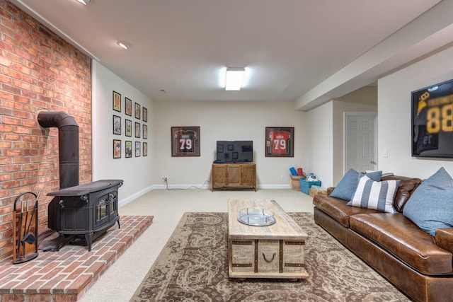 carpeted living area featuring a wood stove and baseboards