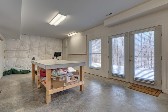 basement featuring visible vents and french doors