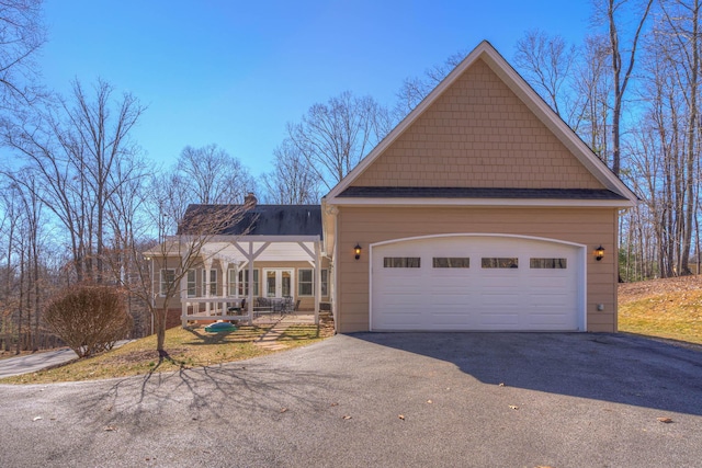 view of front of house with driveway and a chimney