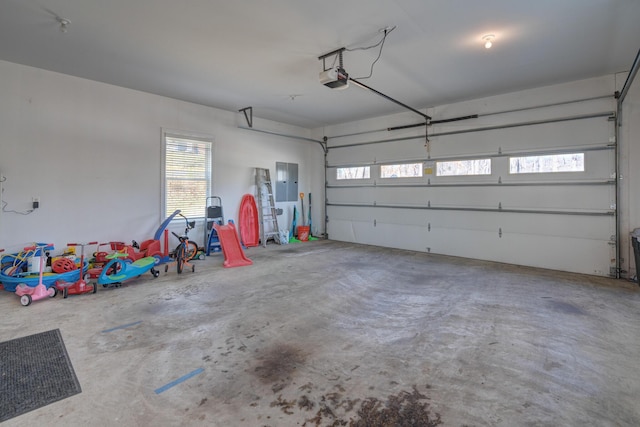 garage with electric panel and a garage door opener