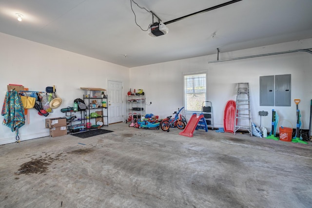 garage featuring electric panel and a garage door opener