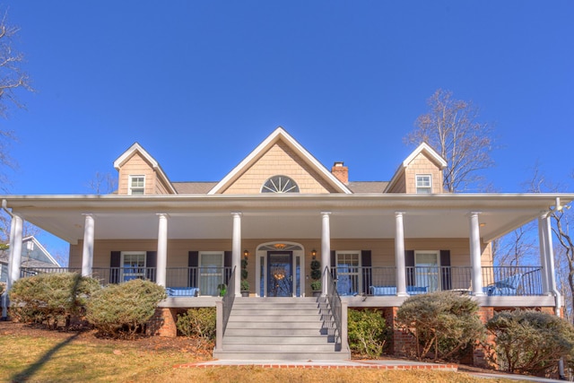 view of front of home featuring stairs and a porch