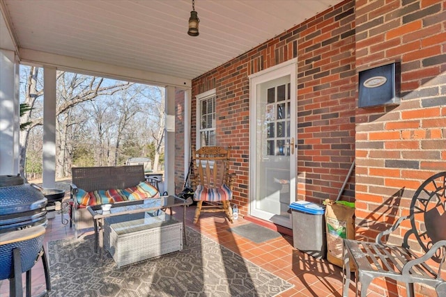 view of patio featuring grilling area and a porch