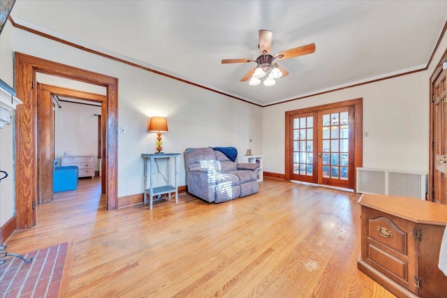 sitting room with crown molding, radiator heating unit, french doors, and light wood finished floors