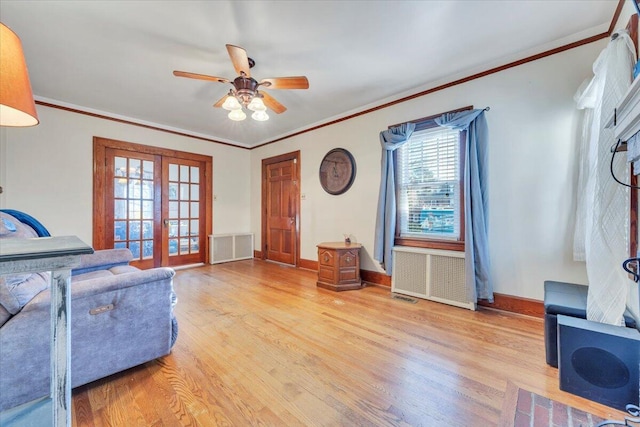 living room with visible vents, crown molding, baseboards, light wood-type flooring, and french doors