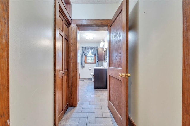 corridor with stone tile flooring
