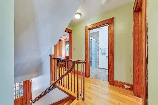 bonus room featuring baseboards and light wood finished floors