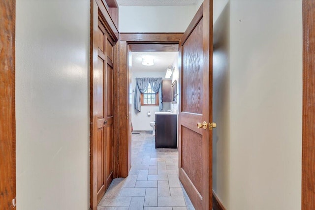 hall with stone tile floors