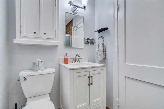 bathroom with toilet and vanity