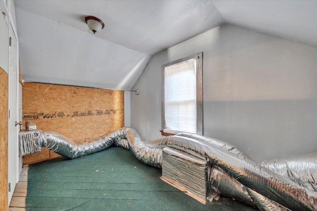 unfurnished bedroom with vaulted ceiling