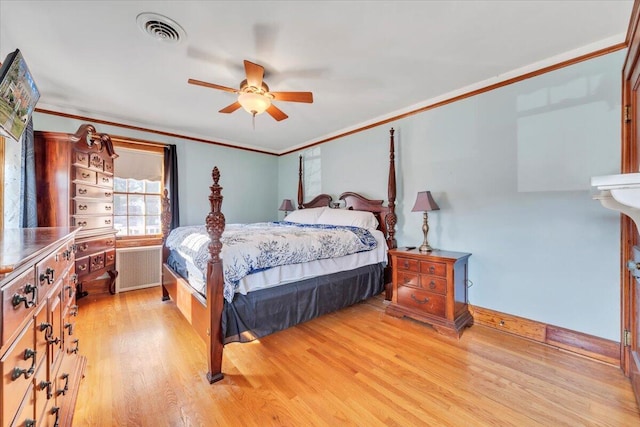 bedroom featuring radiator, visible vents, ceiling fan, crown molding, and light wood-type flooring