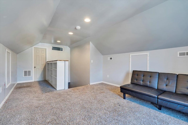 interior space featuring lofted ceiling, carpet, and visible vents