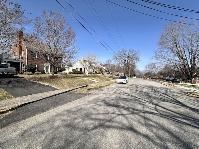 view of street featuring a residential view and curbs