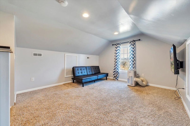 living area featuring visible vents, carpet floors, baseboards, and vaulted ceiling