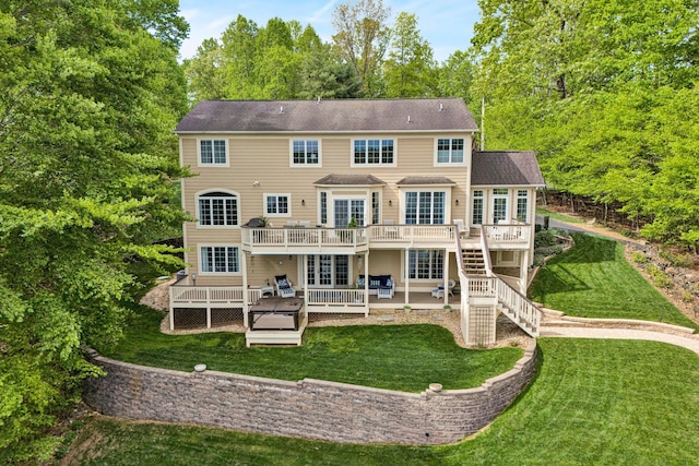 back of house with a wooden deck, a patio, a yard, and stairs