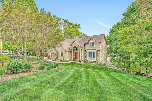 view of front of home featuring a front lawn and stone siding