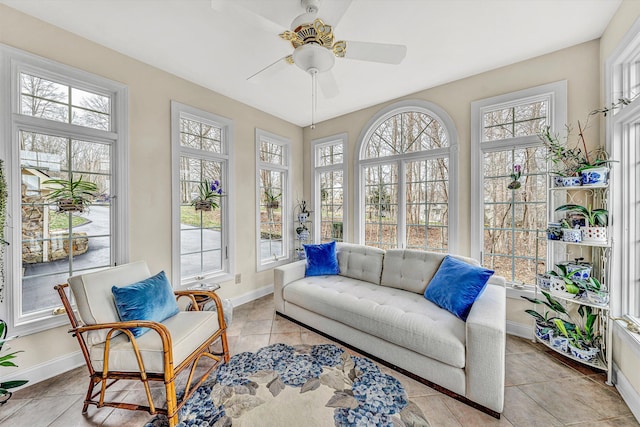 sunroom featuring a ceiling fan and a healthy amount of sunlight