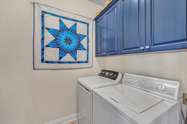 clothes washing area with baseboards, cabinet space, and washing machine and clothes dryer