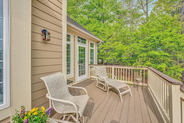 wooden terrace featuring view of scattered trees