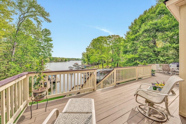 wooden terrace featuring a water view and view of wooded area