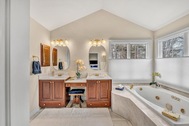 bathroom featuring a jetted tub, lofted ceiling, tile patterned flooring, and double vanity