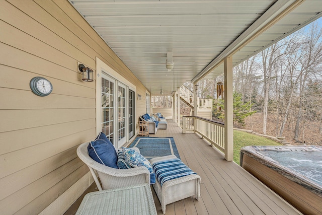 wooden terrace featuring an outdoor hot tub