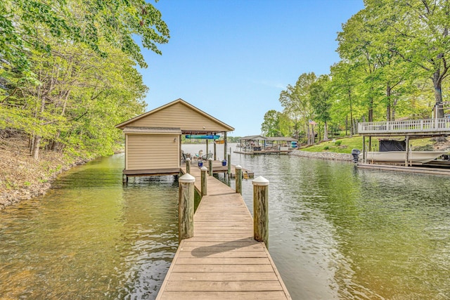 dock featuring boat lift and a water view