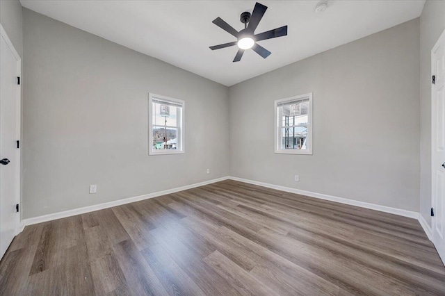 unfurnished bedroom featuring baseboards, wood finished floors, and a ceiling fan