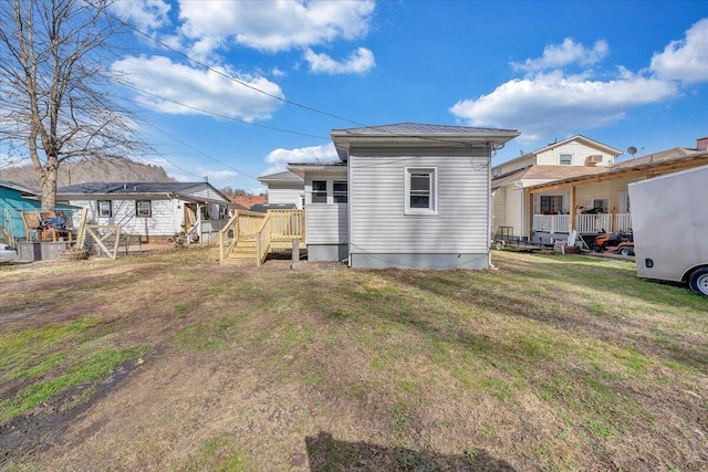 rear view of property with a yard