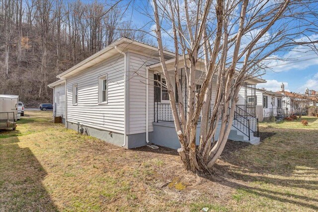 view of home's exterior with a yard