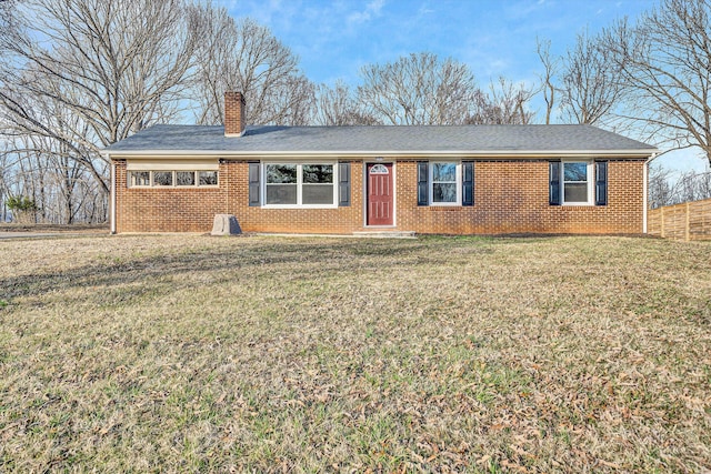 single story home with a front yard, fence, brick siding, and a chimney