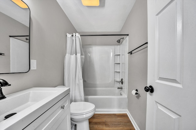 full bathroom featuring vanity, wood finished floors, baseboards, shower / bath combo, and toilet