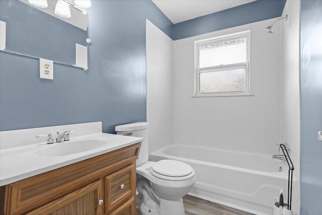 bathroom with vanity, shower / bathing tub combination, toilet, and wood finished floors