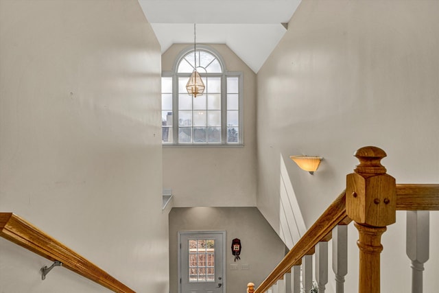 staircase with lofted ceiling