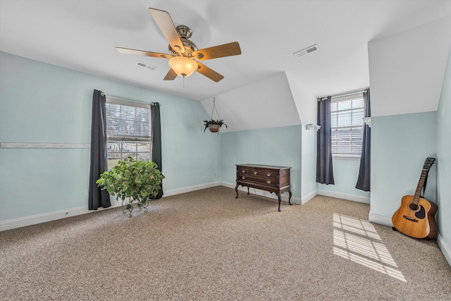 additional living space with lofted ceiling, carpet flooring, visible vents, and ceiling fan