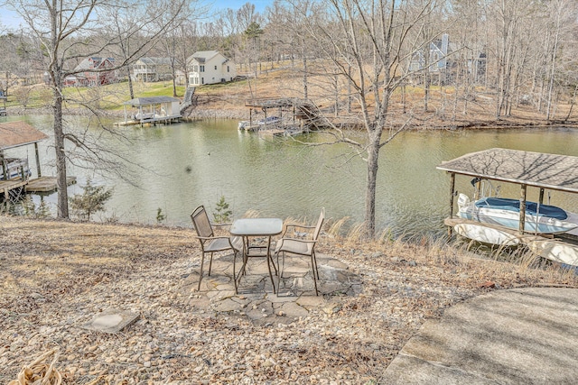 view of yard with a water view and a boat dock