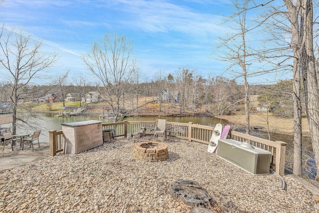 view of yard featuring a fire pit and a water view