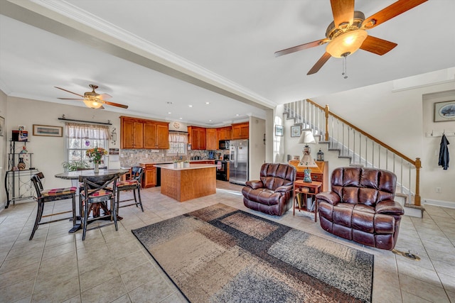 living area featuring ceiling fan, baseboards, stairs, ornamental molding, and light tile patterned floors