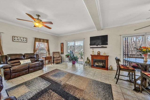 tiled living room featuring a wealth of natural light, a fireplace, crown molding, and ceiling fan