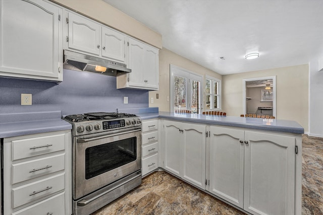 kitchen with under cabinet range hood, stainless steel gas stove, a peninsula, and white cabinets