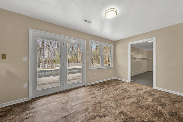 unfurnished bedroom with access to exterior, visible vents, and baseboards