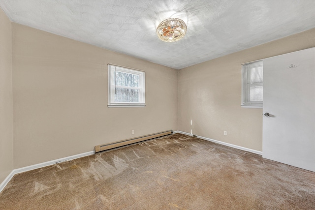 spare room featuring a textured ceiling, baseboards, carpet, and a baseboard radiator