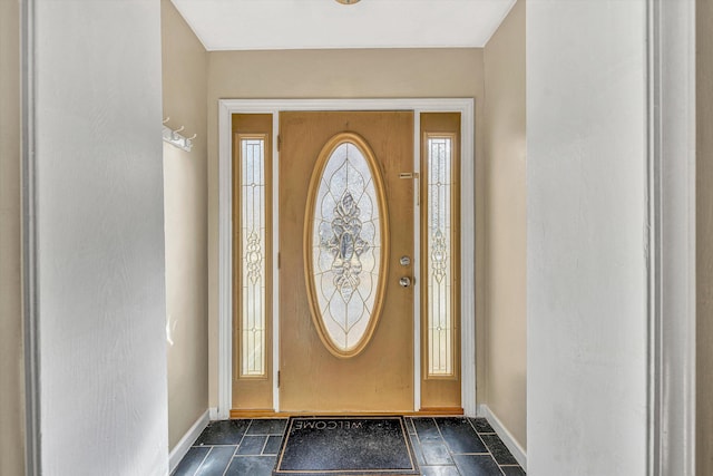 foyer entrance featuring baseboards