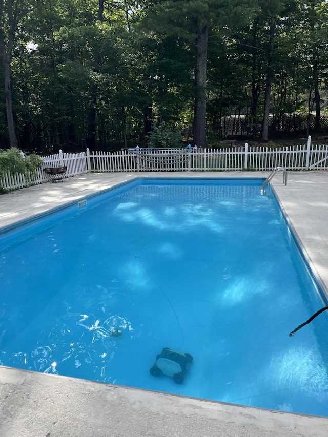 view of pool with a fenced in pool and fence