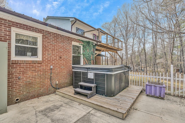 wooden deck with cooling unit, a patio, fence, and a hot tub