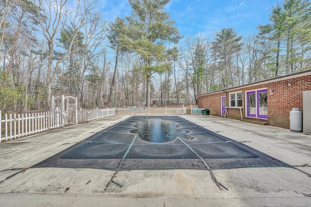 view of pool with a swimming pool and fence