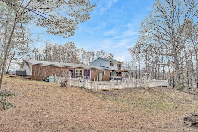 back of house with brick siding, a patio area, and fence private yard