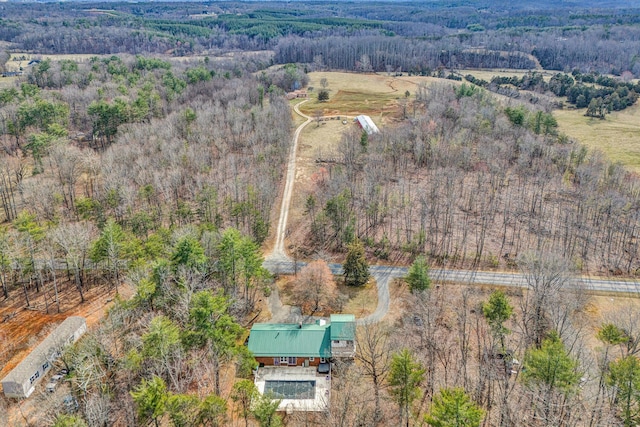 drone / aerial view with a wooded view